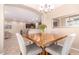A dining room features a square table with modern chairs, plus neutral paint and modern light fixture at 4752 E Portola Valley Dr # 103, Gilbert, AZ 85297