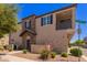 Attractive townhome with a stone facade and balcony, set on a corner lot at 4752 E Portola Valley Dr # 103, Gilbert, AZ 85297