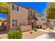 Attractive two-story home with stone accents, well-maintained landscaping, and a private balcony at 4752 E Portola Valley Dr # 103, Gilbert, AZ 85297