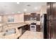 A kitchen with granite countertops, stainless steel appliances, and dark wood cabinets offers style and functionality at 4752 E Portola Valley Dr # 103, Gilbert, AZ 85297