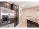 A kitchen showcases a stainless steel refrigerator, granite countertops, dark wood cabinets, and modern appliances at 4752 E Portola Valley Dr # 103, Gilbert, AZ 85297