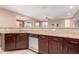 A kitchen counter features granite countertops, stainless steel appliances, and dark wood cabinets at 4752 E Portola Valley Dr # 103, Gilbert, AZ 85297