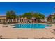 Relax and unwind at the large community pool, surrounded by trees and lounge chairs at 4752 E Portola Valley Dr # 103, Gilbert, AZ 85297
