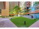 Beautiful courtyard with lush green lawn and inviting outdoor seating next to striking modern building at 4808 N 24Th St # 806, Phoenix, AZ 85016