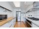 Modern kitchen with stainless steel appliances, white cabinets, and a wooden countertop breakfast bar at 4808 N 24Th St # 806, Phoenix, AZ 85016
