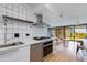 A contemporary kitchen featuring a stainless steel oven, sleek tile backsplash, and modern fixtures at 4808 N 24Th St # 806, Phoenix, AZ 85016