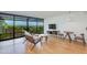 Bright living room with wood floors, modern furniture, and floor-to-ceiling windows with city views at 4808 N 24Th St # 806, Phoenix, AZ 85016