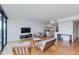 Sun-filled living room featuring hardwood floors, stylish furniture, and a sleek entertainment center at 4808 N 24Th St # 806, Phoenix, AZ 85016