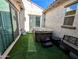 Cozy backyard features a hot tub, bench, and artificial turf for low-maintenance outdoor living at 5304 S Wesley S Cir, Mesa, AZ 85212