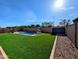 Spacious backyard featuring a pool, well-maintained synthetic grass, and clear boundary walls at 5304 S Wesley S Cir, Mesa, AZ 85212