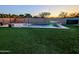 Backyard showcasing a pool, lush artificial grass, and ambient LED lighting for nighttime enjoyment at 5304 S Wesley S Cir, Mesa, AZ 85212