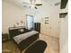 Cozy bedroom featuring a ceiling fan, a black bed frame, and dandelion and butterfly wall art at 5304 S Wesley S Cir, Mesa, AZ 85212