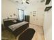 Well-lit bedroom featuring a bed, rug, and storage shelves at 5304 S Wesley S Cir, Mesa, AZ 85212
