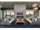 Inviting clubhouse lounge area with a stone fireplace, large screen television and modern furnishings at 5304 S Wesley S Cir, Mesa, AZ 85212