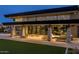 Elegant clubhouse featuring an outdoor lounge, modern architecture, and a well-maintained lawn at 5304 S Wesley S Cir, Mesa, AZ 85212