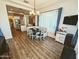 Inviting dining area with wood floors, a built-in bench, and stylish lighting fixture, creating a cozy atmosphere at 5304 S Wesley S Cir, Mesa, AZ 85212