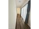 Light-filled hallway featuring wood floors and luxurious window coverings, creating an inviting pathway at 5304 S Wesley S Cir, Mesa, AZ 85212
