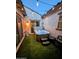 Cozy patio featuring a well-maintained hot tub, synthetic grass, and ambient string lights for relaxation at 5304 S Wesley S Cir, Mesa, AZ 85212