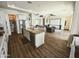 Open concept kitchen with stainless steel appliances, granite counters, and modern finishes flowing into the living room at 5304 S Wesley S Cir, Mesa, AZ 85212