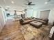 Spacious living room with a comfortable sectional sofa, area rug, and an open layout leading to the kitchen at 5304 S Wesley S Cir, Mesa, AZ 85212