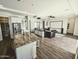 Bright, open floorplan with kitchen island, living room with projector, and easy backyard access at 5304 S Wesley S Cir, Mesa, AZ 85212