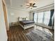 Spacious main bedroom with tray ceilings, ceiling fan, wood floors, and large windows at 5304 S Wesley S Cir, Mesa, AZ 85212