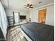 Bright main bedroom featuring wood floors, a ceiling fan, and a large window with neutral colors at 5304 S Wesley S Cir, Mesa, AZ 85212