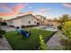 Inviting backyard with a refreshing pool, green artificial turf, and comfortable lounge chairs at 537 E Balao Dr, Phoenix, AZ 85085