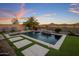 Beautiful backyard pool with mountain views, waterfall feature, and low-maintenance artificial turf at 537 E Balao Dr, Phoenix, AZ 85085