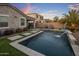 A refreshing backyard pool with unique stone pavers, lush turf, and inviting lounge area at 537 E Balao Dr, Phoenix, AZ 85085