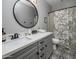 Beautiful bathroom with stylish vanity, round mirror, and patterned tile flooring at 537 E Balao Dr, Phoenix, AZ 85085