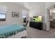 Cozy bedroom featuring a modern dresser with a television and an ensuite bathroom at 537 E Balao Dr, Phoenix, AZ 85085