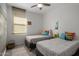 Welcoming bedroom with twin beds, soft lighting, and a comforting decor at 537 E Balao Dr, Phoenix, AZ 85085