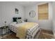 Bright bedroom with a unique patterned accent wall, decorative pillows, and natural light at 537 E Balao Dr, Phoenix, AZ 85085