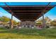 Community outdoor patio with a fireplace, covered seating, and meticulously maintained landscape at 537 E Balao Dr, Phoenix, AZ 85085