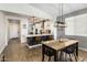 Dining area with an open view of the modern kitchen with white cabinets and stainless steel appliances at 537 E Balao Dr, Phoenix, AZ 85085