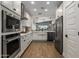 Kitchen features stainless steel appliances, white cabinets, and view of open floor plan at 537 E Balao Dr, Phoenix, AZ 85085