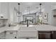 Bright open-concept kitchen with white countertops, a farmhouse sink, and views to the living space at 537 E Balao Dr, Phoenix, AZ 85085