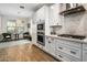 Charming kitchen featuring white cabinets, modern appliances, and a cozy breakfast nook at 537 E Balao Dr, Phoenix, AZ 85085