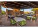 Inviting outdoor kitchen and dining area with a fireplace, barbecue, and ample seating for entertaining at 537 E Balao Dr, Phoenix, AZ 85085