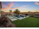 Backyard view of the private pool, palm trees, and desert landscape at 537 E Balao Dr, Phoenix, AZ 85085