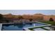 Backyard pool features waterfall feature, desert landscaping and mountain views at 537 E Balao Dr, Phoenix, AZ 85085