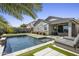 Serene backyard oasis with a sparkling pool, modern pavers, and a comfortable lounge area at 537 E Balao Dr, Phoenix, AZ 85085
