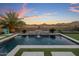 Backyard swimming pool and lounge area at sunset, complete with desert mountain views at 537 E Balao Dr, Phoenix, AZ 85085