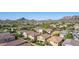 An aerial view of a community with mountain views and lush desert landscaping at 5423 W Yearling Rd, Phoenix, AZ 85083