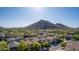Stunning aerial of a neighborhood, set against a mountain backdrop and sunny skies at 5423 W Yearling Rd, Phoenix, AZ 85083