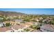 An aerial view of a residential neighborhood showcasing lush desert landscaping, and mountain views at 5423 W Yearling Rd, Phoenix, AZ 85083