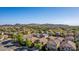 Expansive aerial view of a community with well-maintained homes and mountain views at 5423 W Yearling Rd, Phoenix, AZ 85083