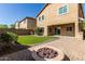 The back of the home features artificial grass and a paved outdoor patio with an outdoor kitchen at 5423 W Yearling Rd, Phoenix, AZ 85083