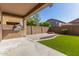 The home has a covered patio, outdoor kitchen, artificial grass and block fence for backyard privacy at 5423 W Yearling Rd, Phoenix, AZ 85083